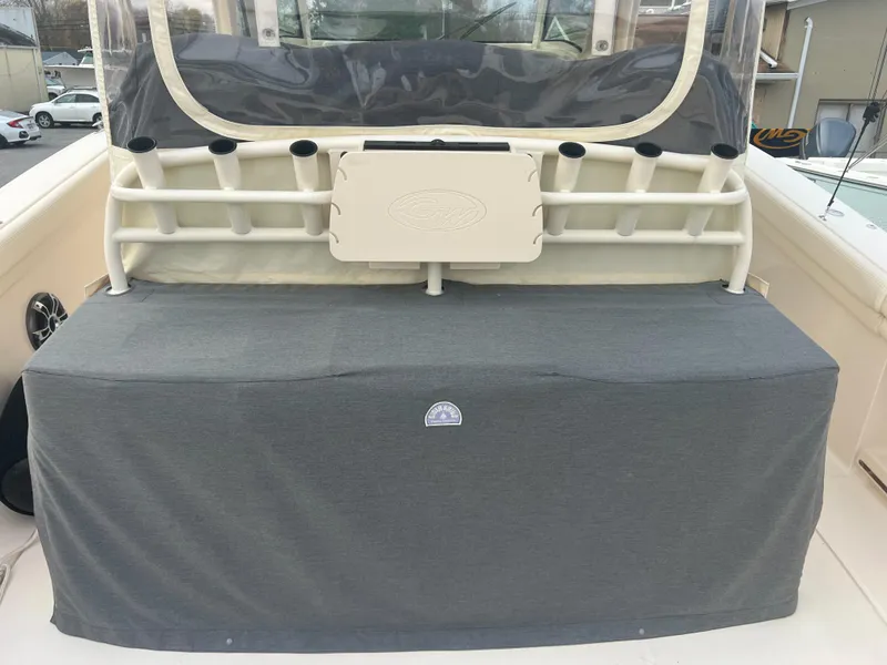 Slide: The Image of 2022 Grady-White Canyon 376 boat with covered seating area and rod holders. - 28