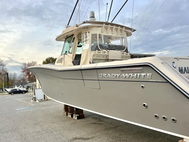 Slide: The Image of 2022 Grady-White Canyon 376 boat on display in a parking lot. - 3