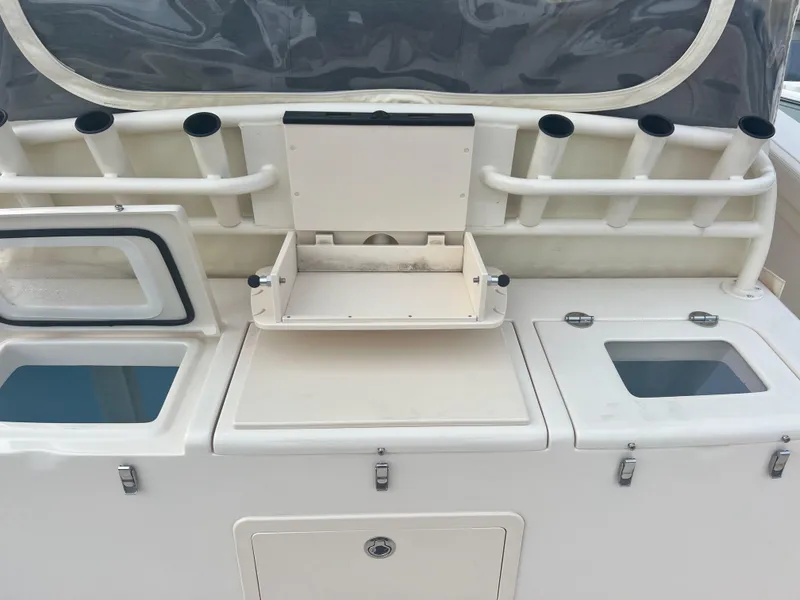 Slide: The Image of Grady-White Canyon 376 boat interior, 2022 model, featuring storage compartments and rod holders. - 30