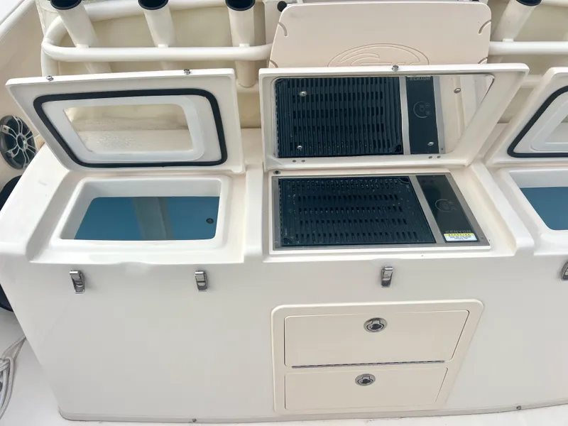Slide: The Image of Grady-White Canyon 376 boat interior, featuring storage compartments and fishing rod holders, 2022 model. - 31