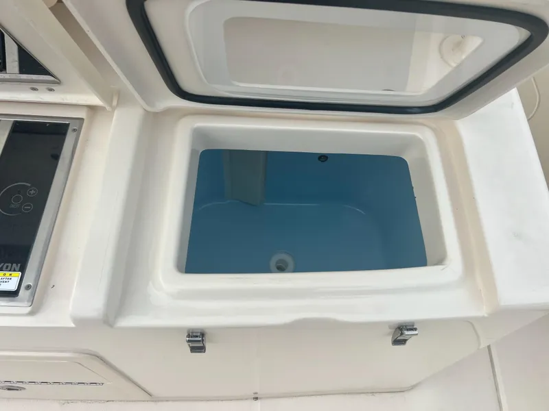 Slide: The Image of Grady-White Canyon 376 2022 boat livewell with open lid, showcasing interior. - 32