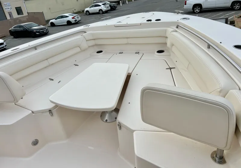 Slide: The Image of 2022 Grady-White Canyon 376 boat interior with white seating and table. - 34