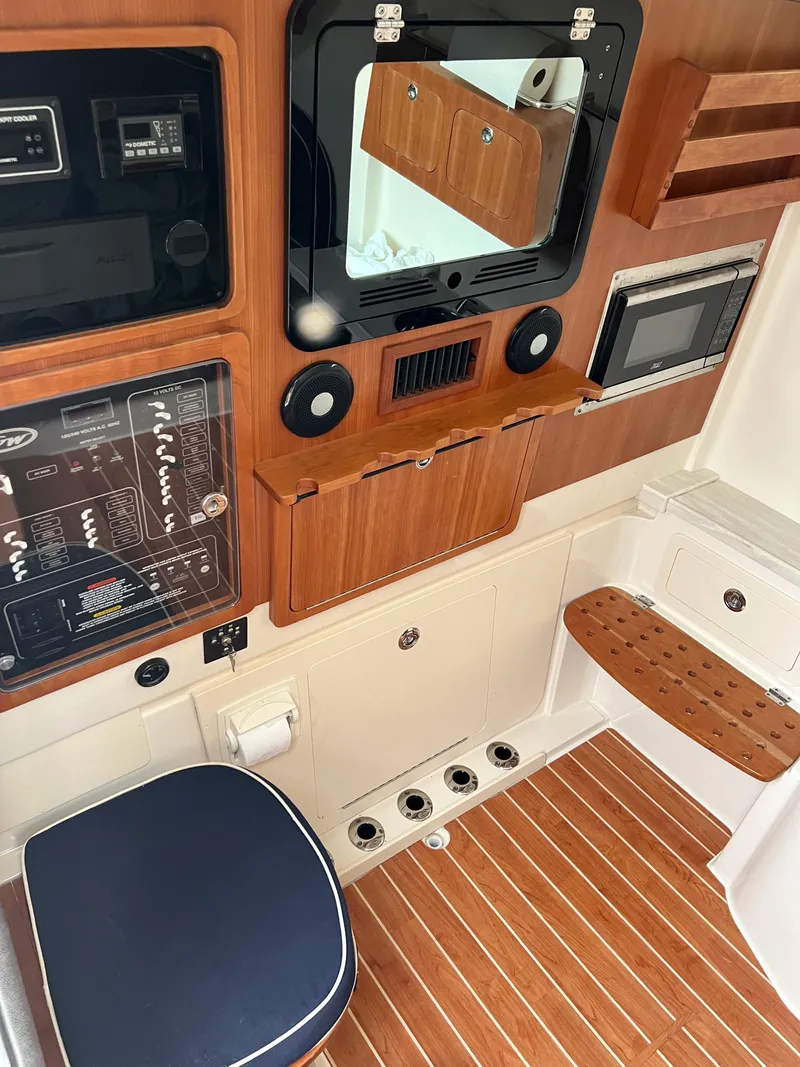 Slide: The Image of Interior of 2022 Grady-White Canyon 376 boat with wood accents and modern controls. - 41