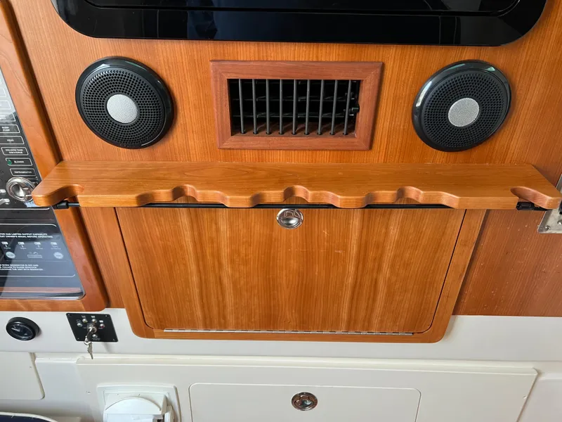 Slide: The Image of 2022 Grady-White Canyon 376 interior with wood paneling and speaker system. - 44