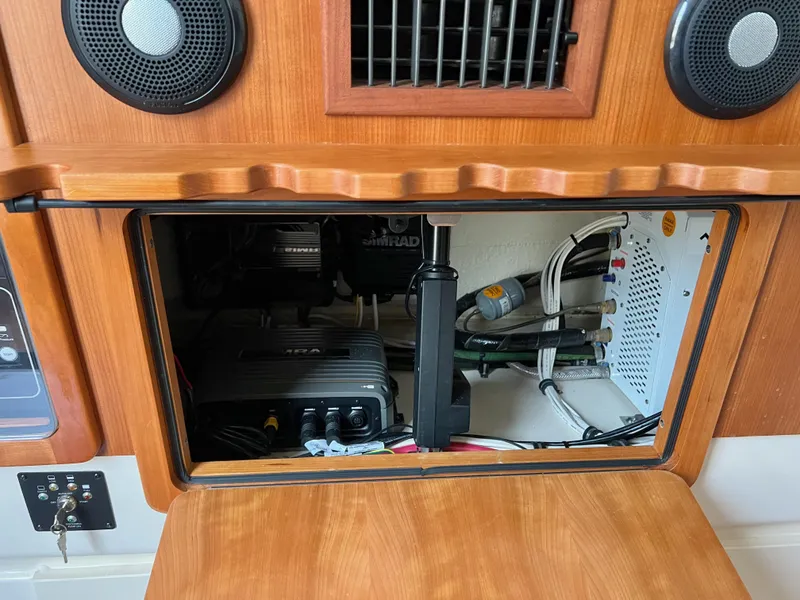 Slide: The Image of 2022 Grady-White Canyon 376 boat electronics compartment with wiring and speakers. - 45