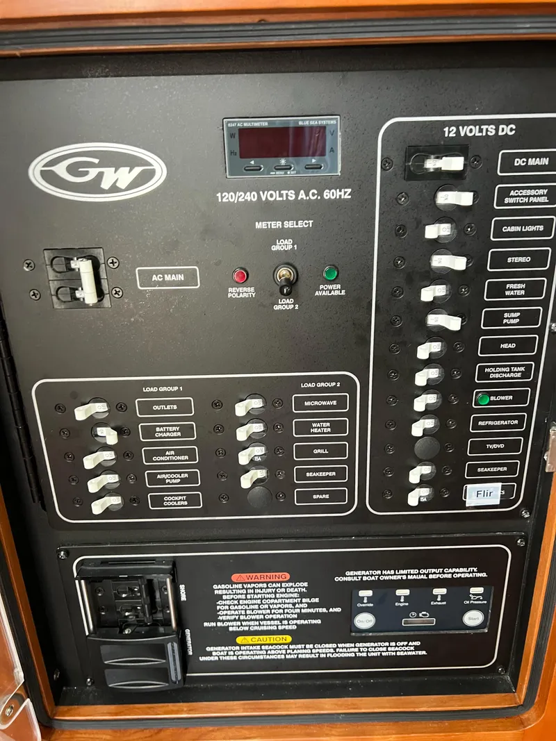 Slide: The Image of Electrical panel of 2022 Grady-White Canyon 376 boat, featuring AC/DC controls and switches. - 47