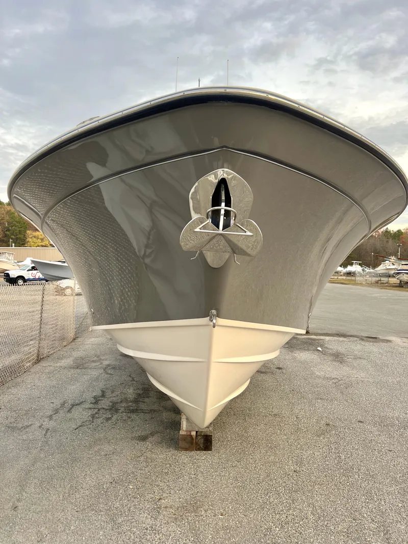 Slide: The Image of 2022 Grady-White Canyon 376 boat, front view, parked on gravel. - 5