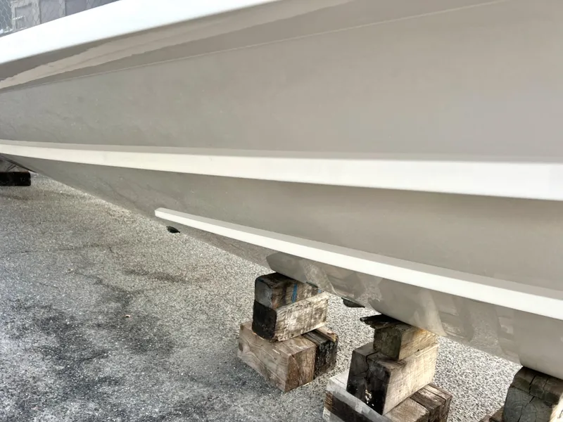 Slide: The Image of 2022 Grady-White Canyon 376 boat hull on wooden blocks. - 7