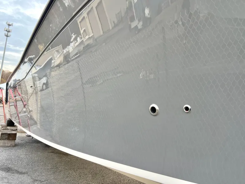 Slide: The Image of 2022 Grady-White Canyon 376 boat hull, sleek gray finish, docked outdoors. - 8