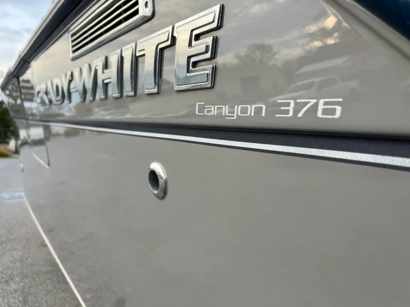 Slide: The Image of 2022 Grady-White Canyon 376 boat side view with logo and model name. - 9