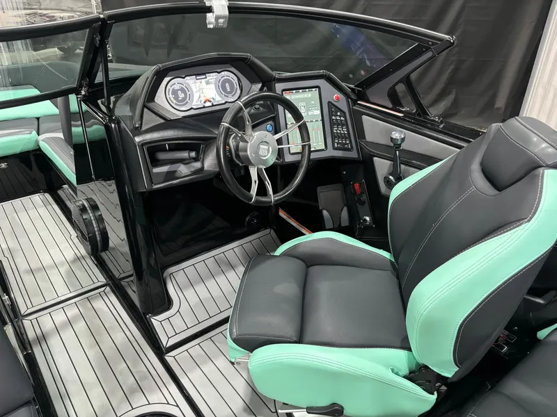 Slide: The Image of 2024 MasterCraft XStar S boat interior with modern dashboard and mint green accents. - 15