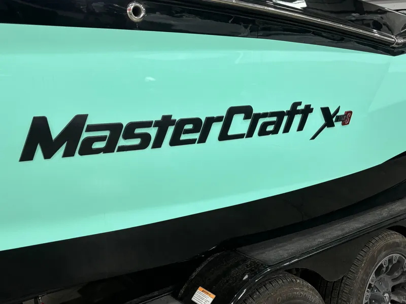 Slide: The Image of 2024 MasterCraft XStar S boat side view with logo. - 3