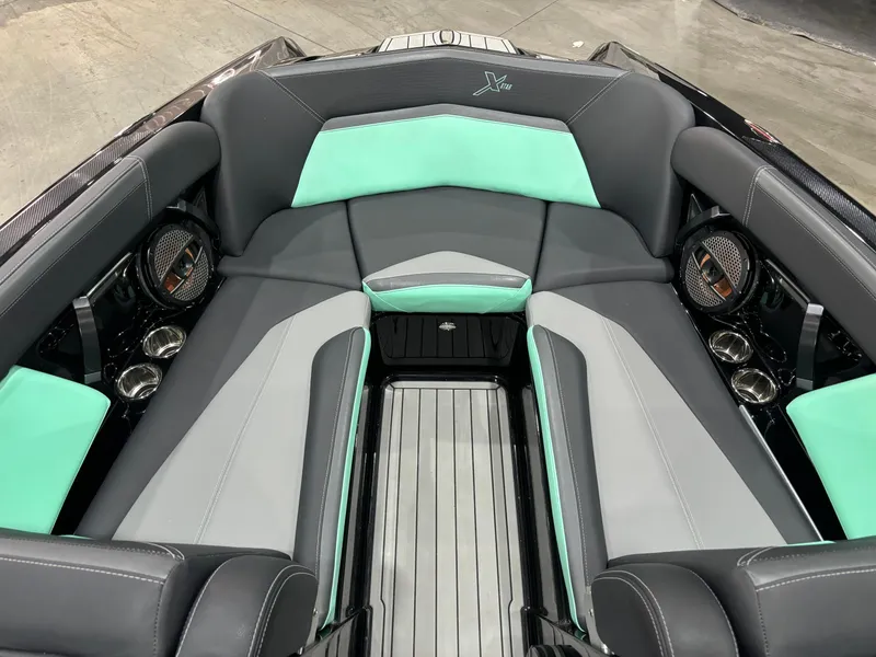 Slide: The Image of 2024 MasterCraft XStar S interior with gray and teal seating, premium audio system. - 5