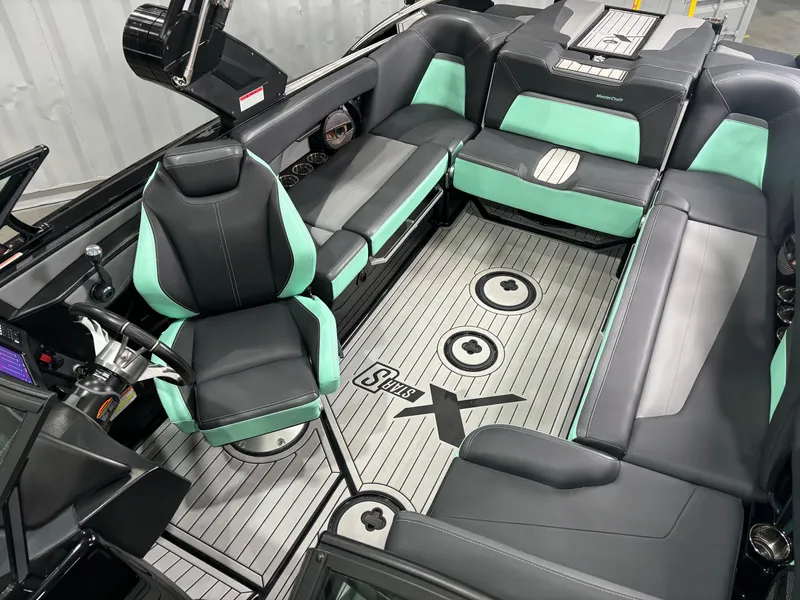 Slide: The Image of 2024 MasterCraft XStar S interior with sleek black and mint seating, modern design. - 7