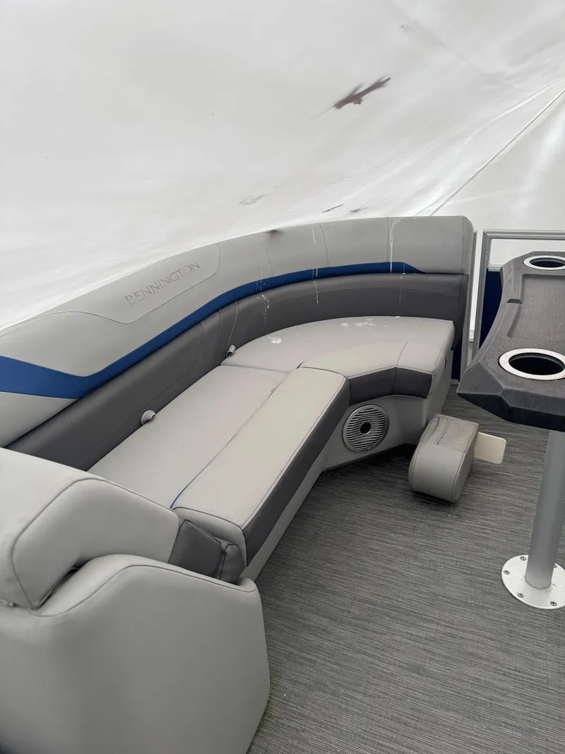 Slide: The Image of 2022 Bennington 23XSSB pontoon boat with Yamaha outboard motor, docked outdoors. - 2