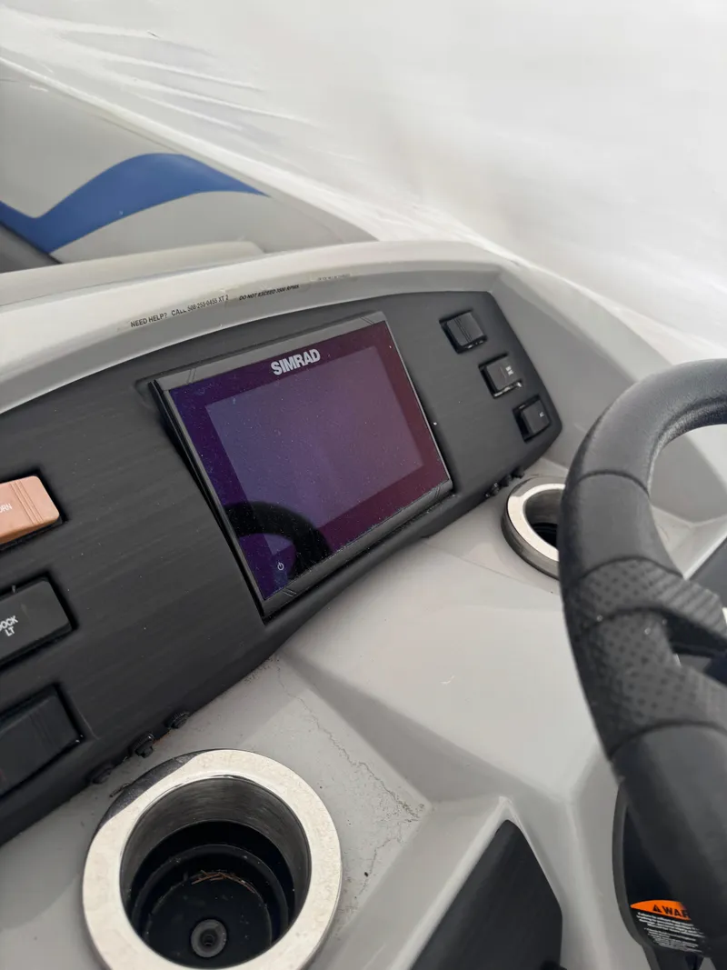 Slide: The Image of 2022 Bennington 23XSSB pontoon boat with Yamaha outboard motor, docked outdoors. - 3