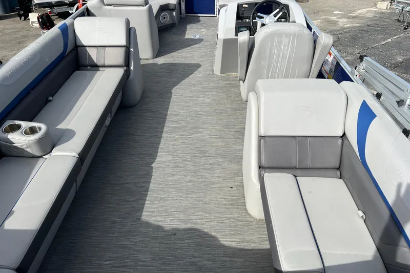 Slide: The Image of 2022 Bennington 23XSSB pontoon boat interior with gray seating and cup holders. - 8