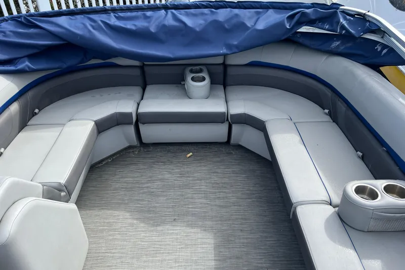 Slide: The Image of 2022 Bennington 23XSSB boat interior with gray seating and cup holders. - 9