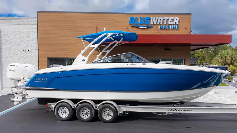 The Image of 2025 Cobalt R8 Outboard boat on trailer at Bluewater Marine dealership. - 1