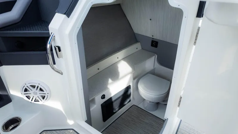 Slide: The Image of 2025 Cobalt R8 Outboard boat interior with compact bathroom and modern design. - 19