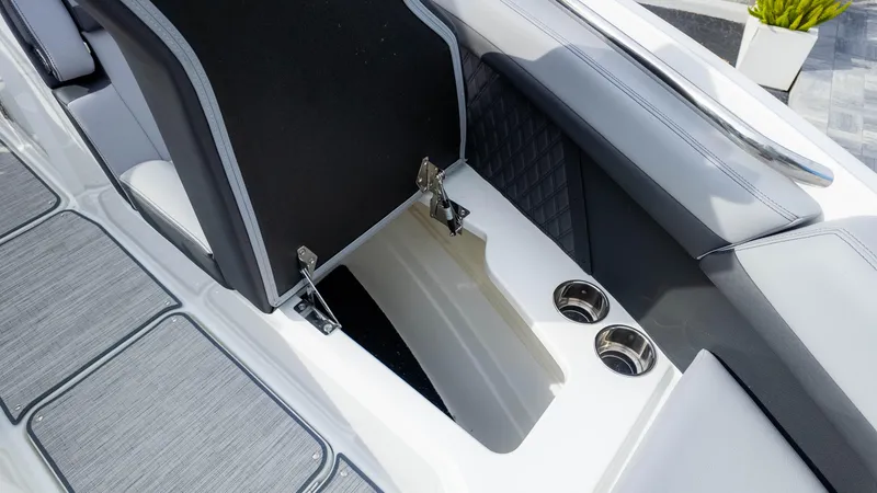 Slide: The Image of 2025 Cobalt R8 Outboard boat interior with storage compartment and cup holders. - 21