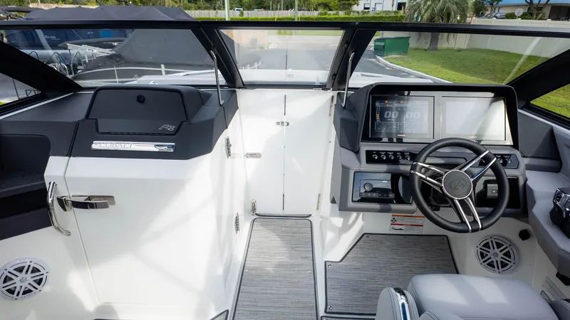 Slide: The Image of 2025 Cobalt R8 Outboard boat cockpit with modern steering and dashboard controls. - 26