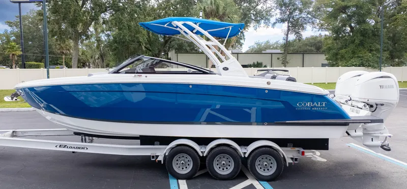 Slide: The Image of 2025 Cobalt R8 Outboard boat on trailer, blue and white design. - 5