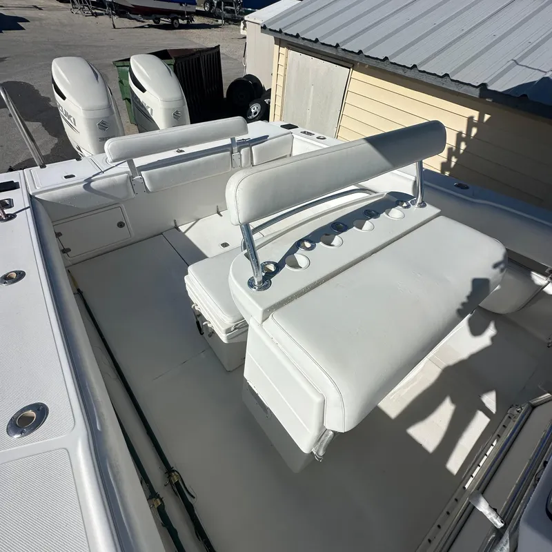 Slide: The Image of 2004 Venture Open Fisherman boat with white seating and dual outboard motors. - 7