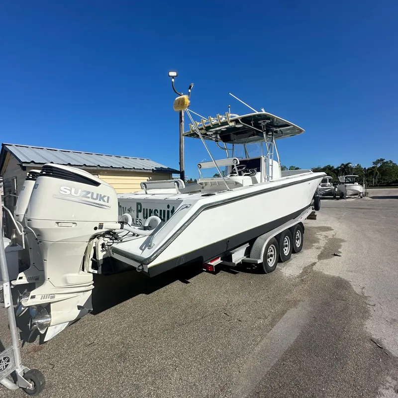 Slide: The Image of 2004 Venture Open Fisherman boat with Suzuki outboard on a trailer. - 8