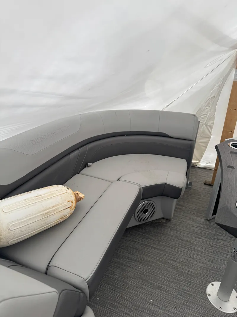 Slide: The Image of Steering console of 2022 Bennington 23SXSRC boat with modern controls and cup holders. - 2