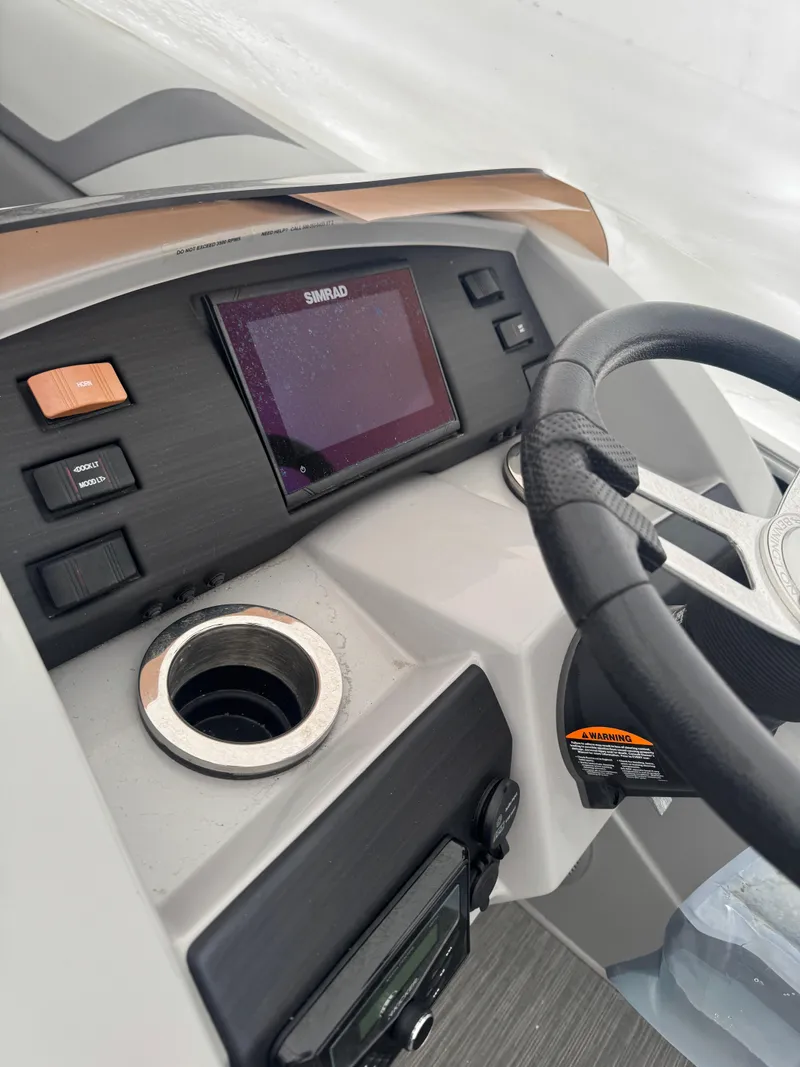 Slide: The Image of 2022 Bennington 23SXSRC pontoon boat interior with gray seating and cup holders. - 5