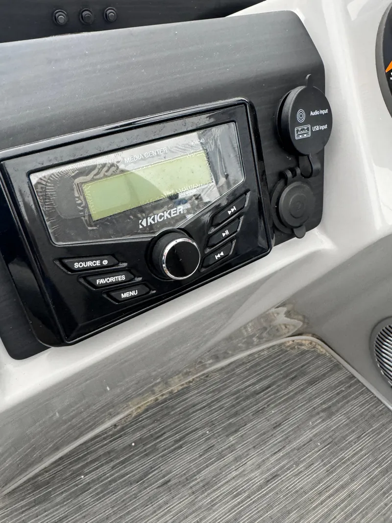 Slide: The Image of 2022 Bennington 23SXSRC boat interior with gray seating and cup holders. - 6