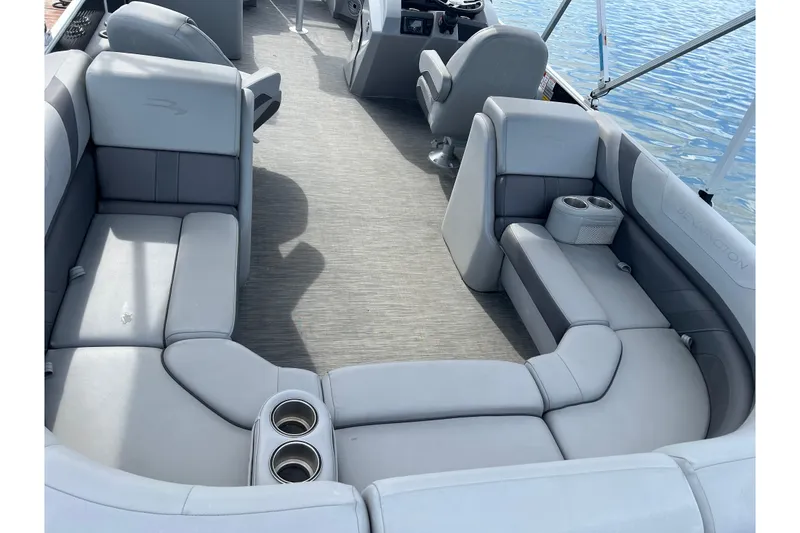 Slide: The Image of 2022 Bennington 23SXSRC pontoon boat interior with plush gray seating and cup holders. - 8