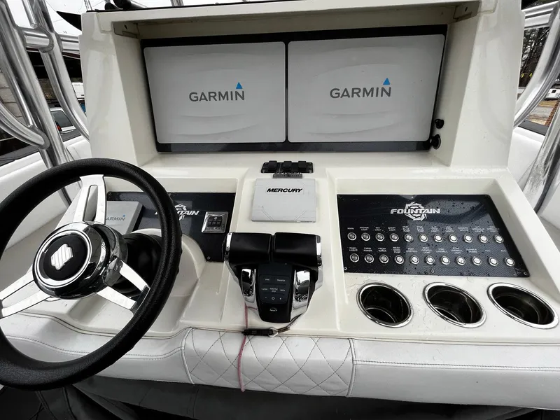 Slide: The Image of 2011 Fountain 38 CC Tournament Edition boat dashboard with Garmin displays and Mercury controls. - 15