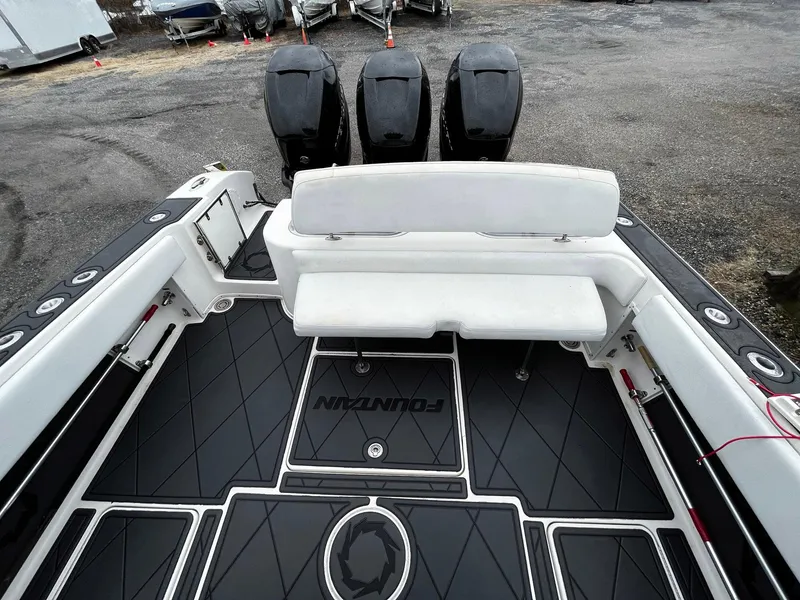Slide: The Image of 2011 Fountain 38 CC Tournament Edition boat with triple outboard engines and spacious seating. - 25