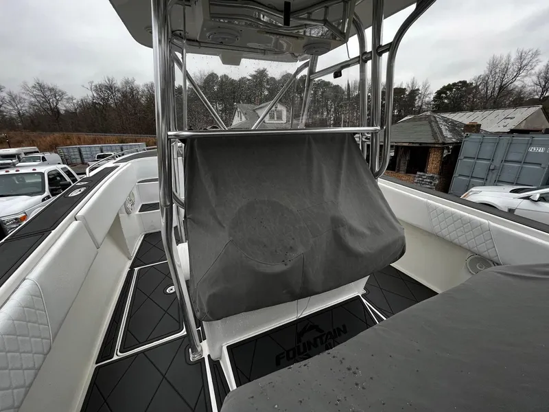 Slide: The Image of 2011 Fountain 38 CC Tournament Edition boat interior with covered console and seating. - 31