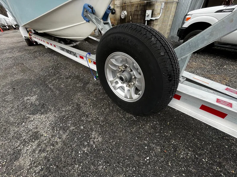 Slide: The Image of Trailer carrying 2011 Fountain 38 CC Tournament Edition boat, close-up of wheel and hull. - 35