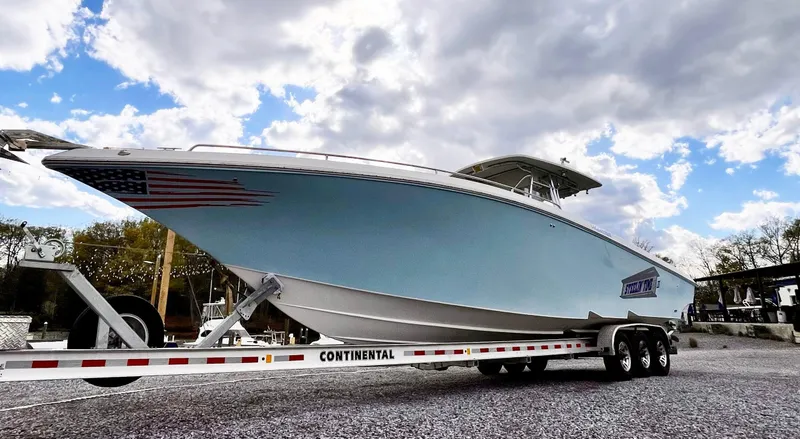 Slide: The Image of 2011 Fountain 38 CC Tournament Edition boat on trailer under cloudy sky. - 36