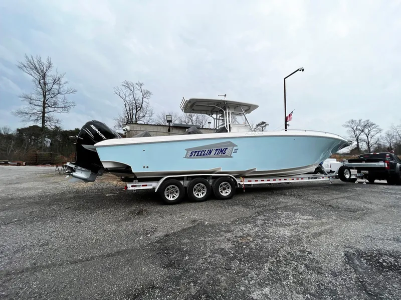 Slide: The Image of 2011 Fountain 38 CC Tournament Edition boat on trailer in parking lot. - 37