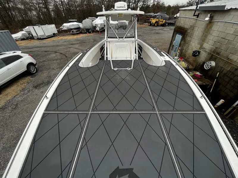 Slide: The Image of 2011 Fountain 38 CC Tournament Edition boat with sleek deck design, parked outdoors. - 6