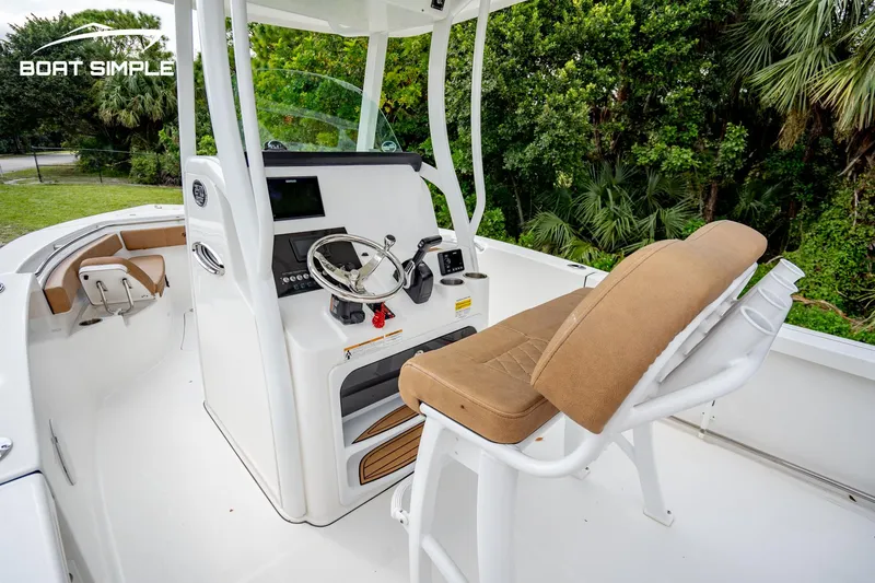 Slide: The Image of 2024 Sea Pro 239 Deep V CC boat interior with helm and seating. - 11