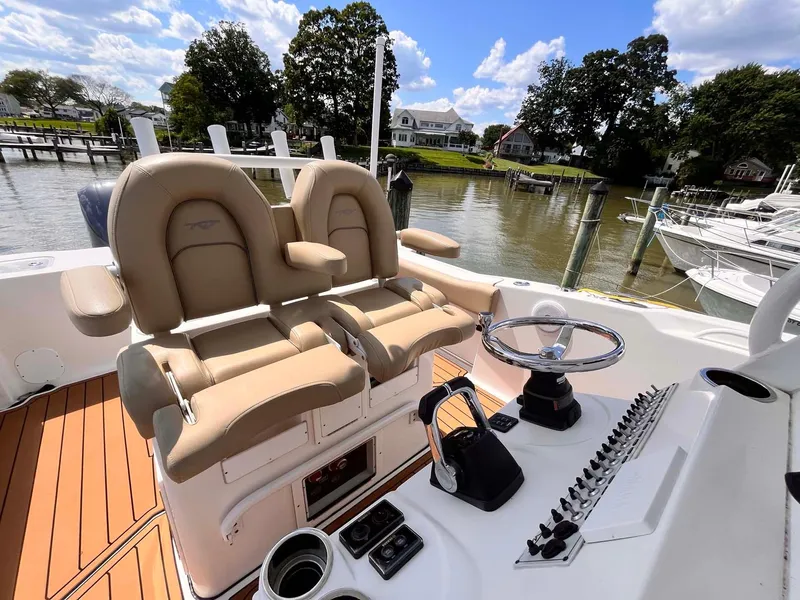 Slide: The Image of 2015 Tidewater 280 CC Adventure boat interior with helm and seating. - 12