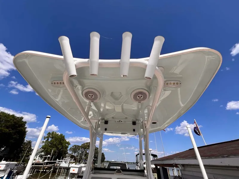 Slide: The Image of 2015 Tidewater 280 CC Adventure boat with rod holders and speakers under a clear blue sky. - 14