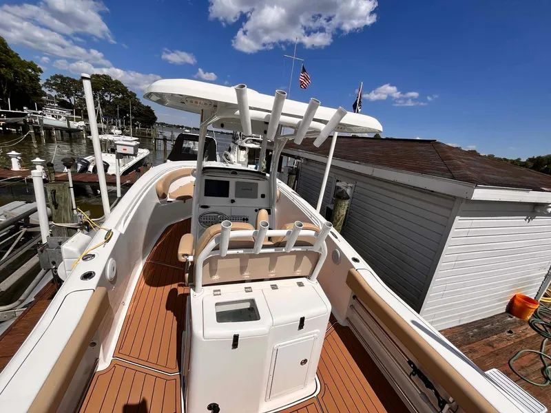 Slide: The Image of 2015 Tidewater 280 CC Adventure boat docked under a clear blue sky. - 16