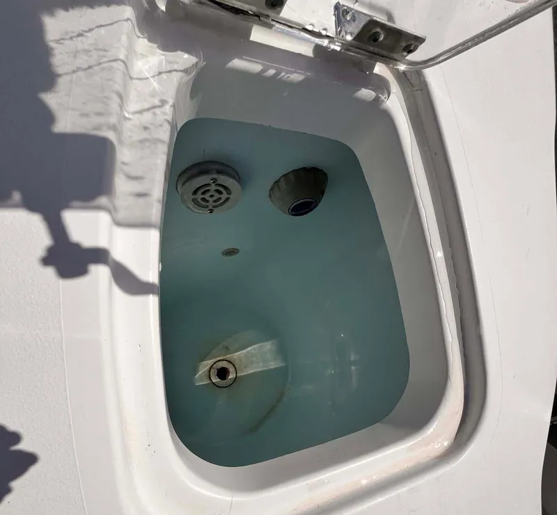 Slide: The Image of Open livewell on 2015 Tidewater 280 CC Adventure boat, filled with water. - 17