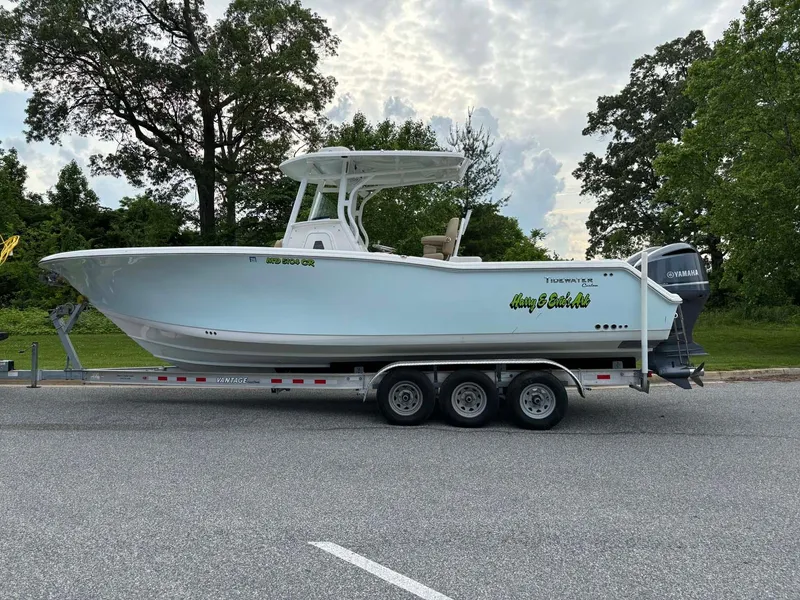 Slide: The Image of 2015 Tidewater 280 CC Adventure boat on trailer, parked outdoors. - 2