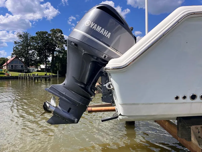Slide: The Image of Yamaha outboard motor on 2015 Tidewater 280 CC Adventure boat by the water. - 24