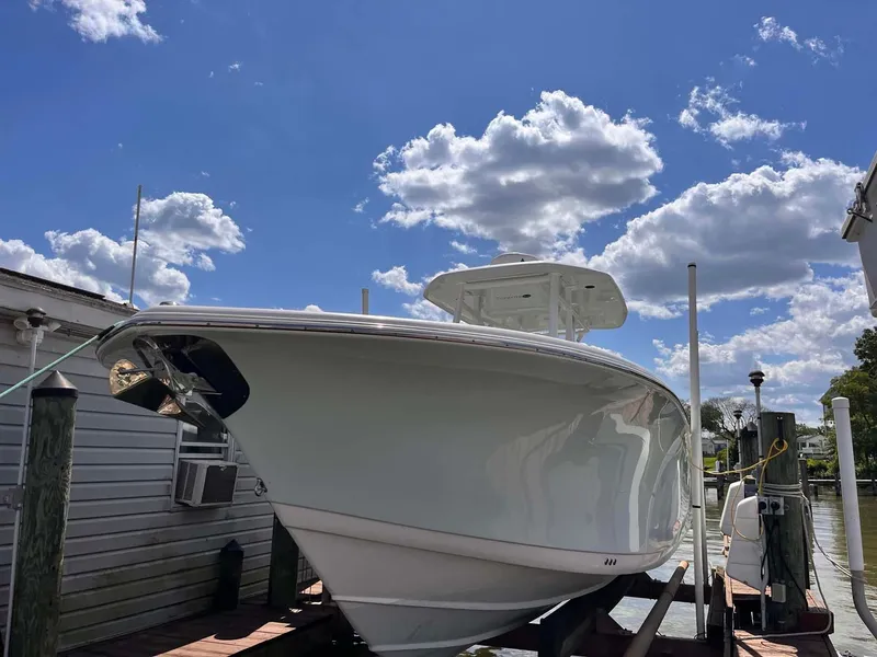 Slide: The Image of 2015 Tidewater 280 CC Adventure boat docked under a bright blue sky. - 27