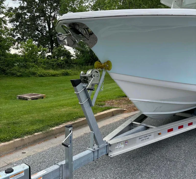 Slide: The Image of 2015 Tidewater 280 CC Adventure boat on trailer, parked on roadside. - 3