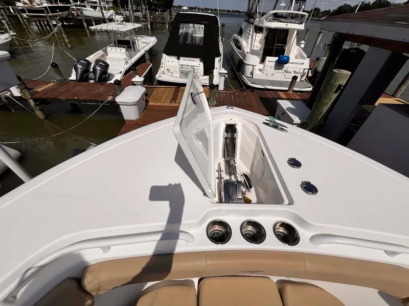 Slide: The Image of 2015 Tidewater 280 CC Adventure boat docked at marina, open storage compartment visible. - 4